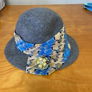 Felt hat with broach and colorful band